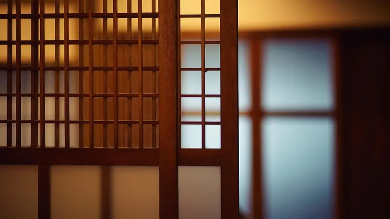 A serene traditional Japanese ryokan room with tatami mats and a low table.